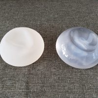 Two,Silicone,Implant,Breast,Rough,And,Smooth,Skin.